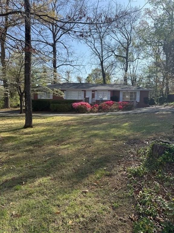 3674 Canton Road Marietta, GA 30066 - Photo 2 of 20 a view of a tree in front of a house