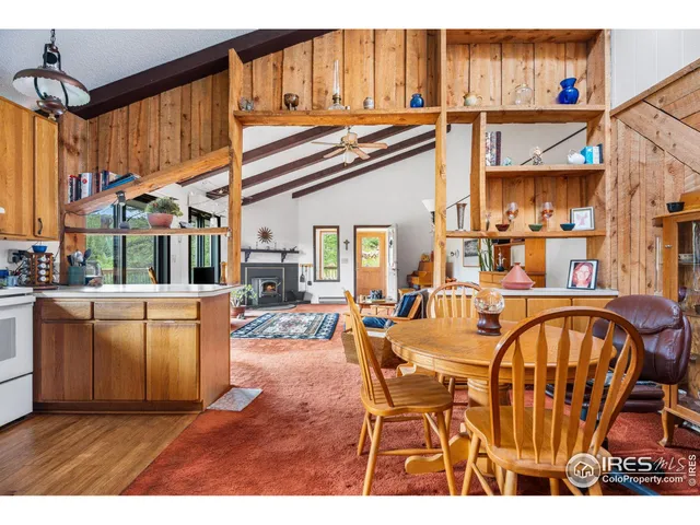 a open kitchen with a table chairs and a wooden floors