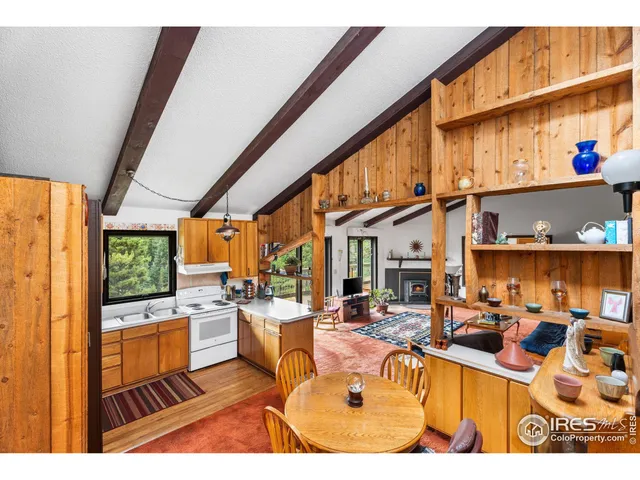 a living room with stainless steel appliances kitchen island granite countertop a sink and cabinets