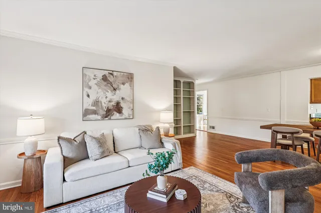 a kitchen with stainless steel appliances granite countertop a refrigerator a stove and a sink with wooden floor