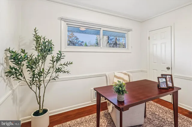 a kitchen with a sink cabinets wooden floor and a window