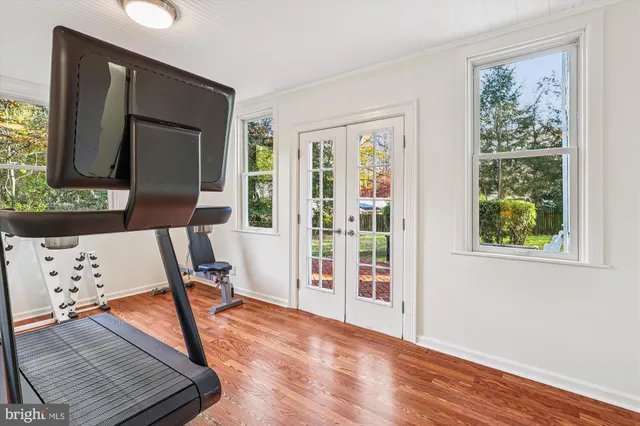 a front view of a house with yard and tree