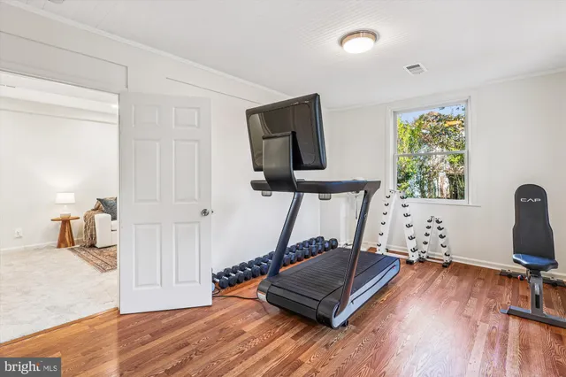 a front view of a house with swimming pool and porch with furniture