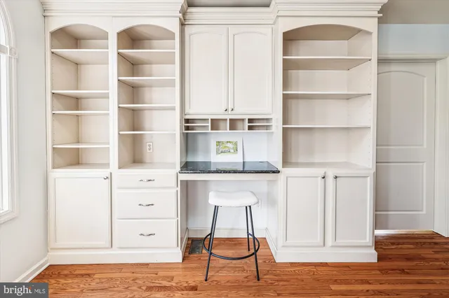 a kitchen with stainless steel appliances granite countertop a stove a sink dishwasher and a dining table with cabinets