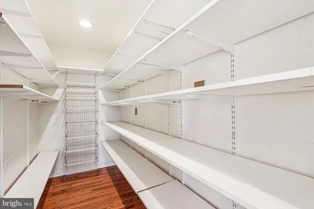 a dining room with furniture a chandelier and wooden floor