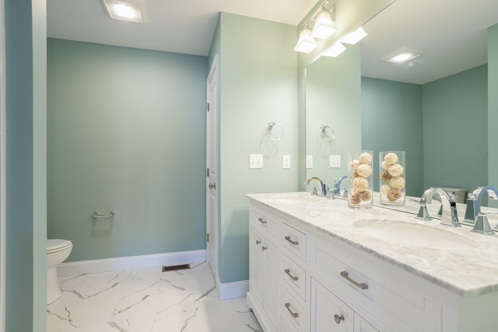 3 Katlyn Circle, Unit 8 Rochester, MA 02770 - Photo 10 of 16 a bathroom with a sink a toilet and a mirror