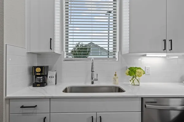 a kitchen with a sink and window