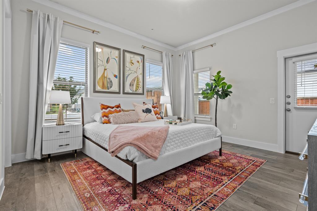 3279 Ganzer Road West, Unit 125B Denton, TX 76207 - Photo 16 of 25 a bedroom with a bed and wooden floor