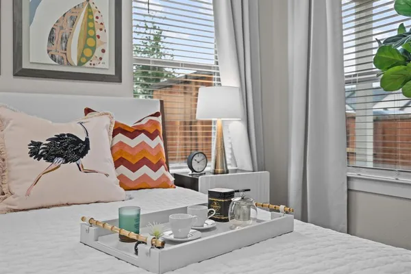 a living room with furniture and wall paintings