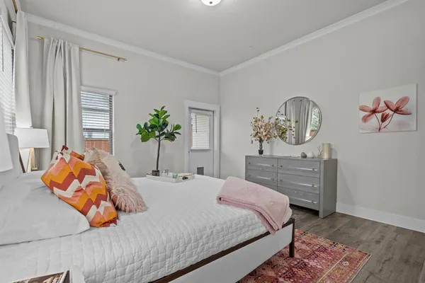 a bedroom with bed and wooden floor