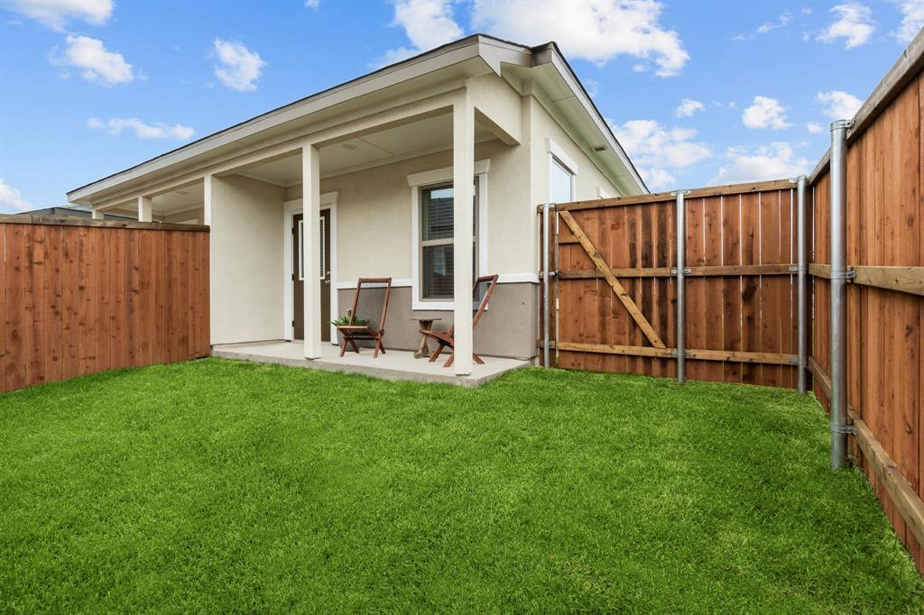 3279 Ganzer Road West, Unit 125B Denton, TX 76207 - Photo 24 of 25 a view of backyard with potted plants and wooden fence