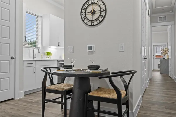 a view of a dining room with furniture and wooden floor