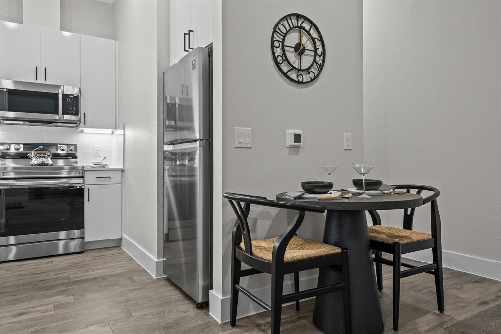 3279 Ganzer Road West, Unit 125B Denton, TX 76207 - Photo 8 of 25 a view of a dining area with furniture and wooden floor