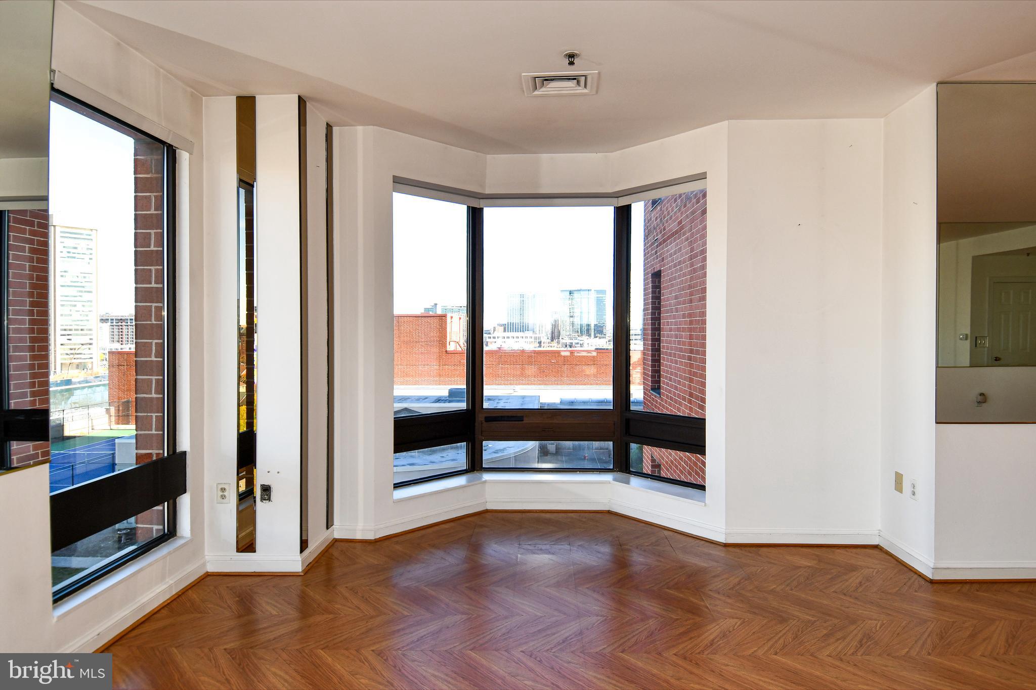 10 East Lee Street, Unit 809 Baltimore, MD 21202 - Photo 13 of 58 a view of an empty room with glass door and balcony