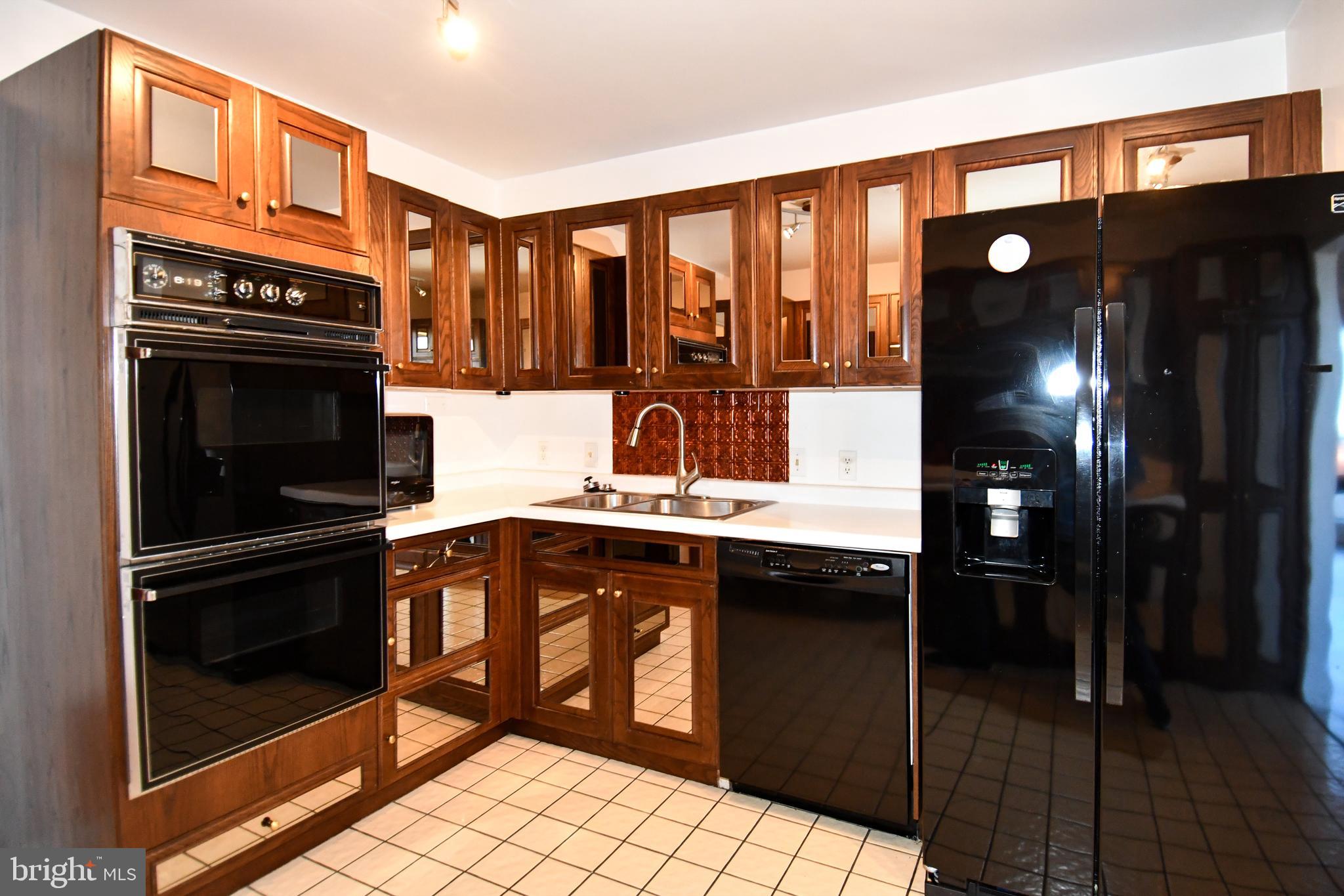 10 East Lee Street, Unit 809 Baltimore, MD 21202 - Photo 58 of 58 a kitchen with stainless steel appliances granite countertop a refrigerator and a sink