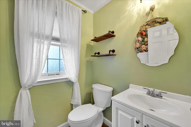 a bathroom with a sink toilet and mirror