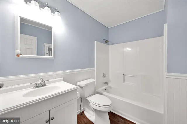 a bathroom with a sink toilet a mirror and shower