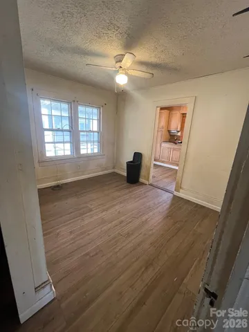 a view of a hallway with furniture and a window
