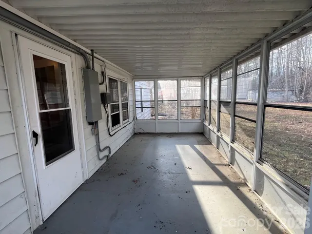 a view of a kitchen counter space a sink wooden floor and a window