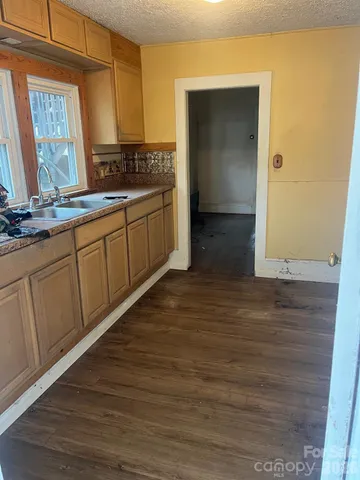 an empty room with windows and fireplace