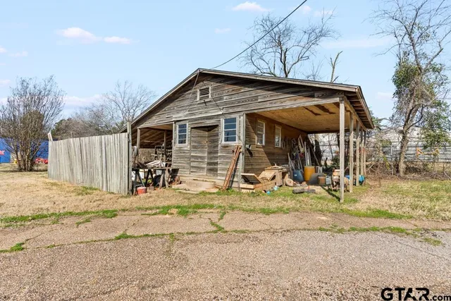 a view of a house with wooden fence