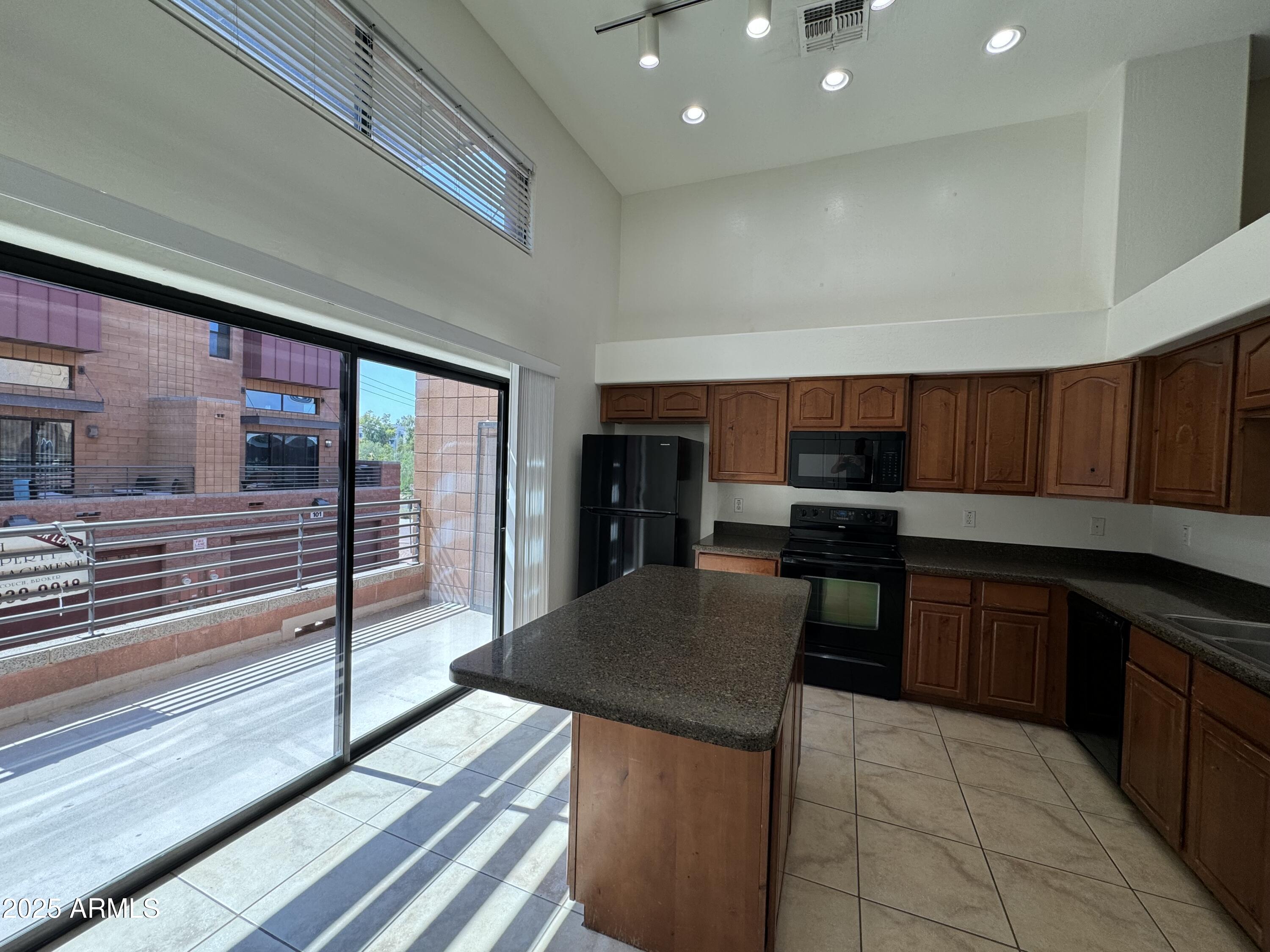 305 South Wilson Street, Unit 111 Tempe, AZ 85281 - Photo 4 of 48 a kitchen with a sink a counter top space and stainless steel appliances