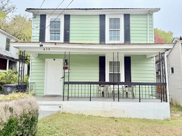 a view of a house with wooden fence