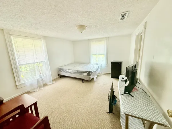 a bedroom with furniture and a window