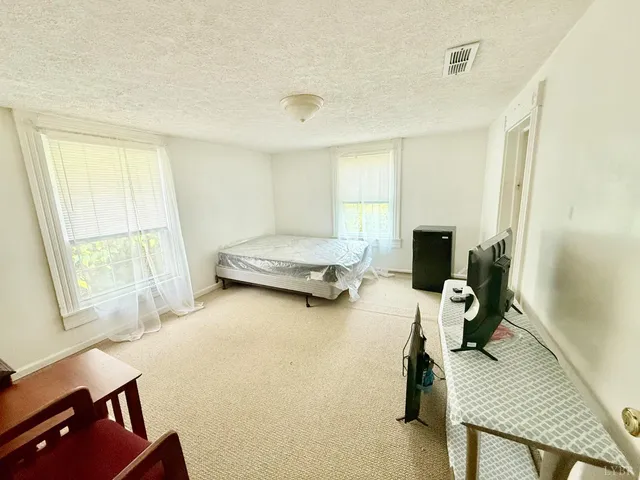 a bedroom with furniture and a window