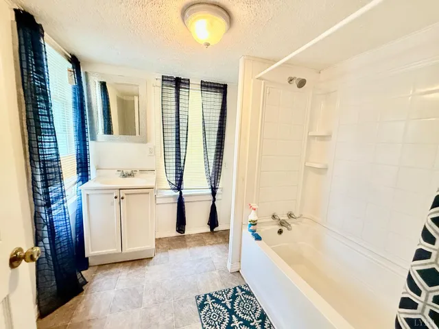 a bathroom with a bathtub a sink and a shower