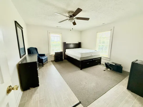 a bedroom with a bed and a chair