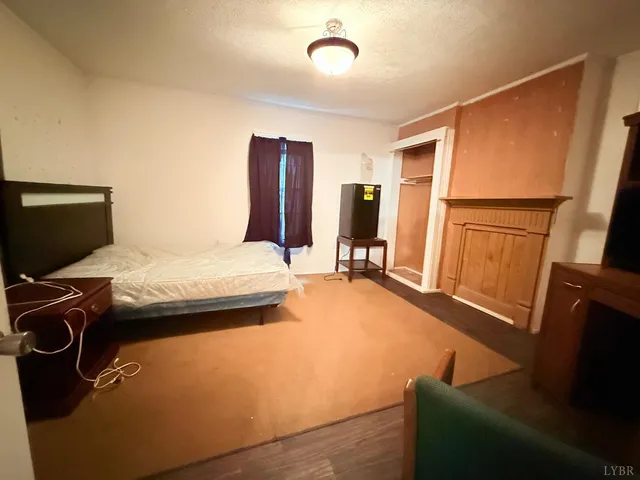 a bedroom with a bed and flat screen tv