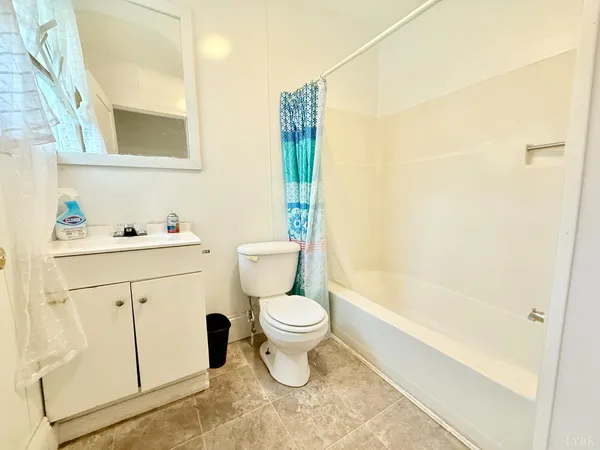 a bathroom with a sink toilet vanity and tub