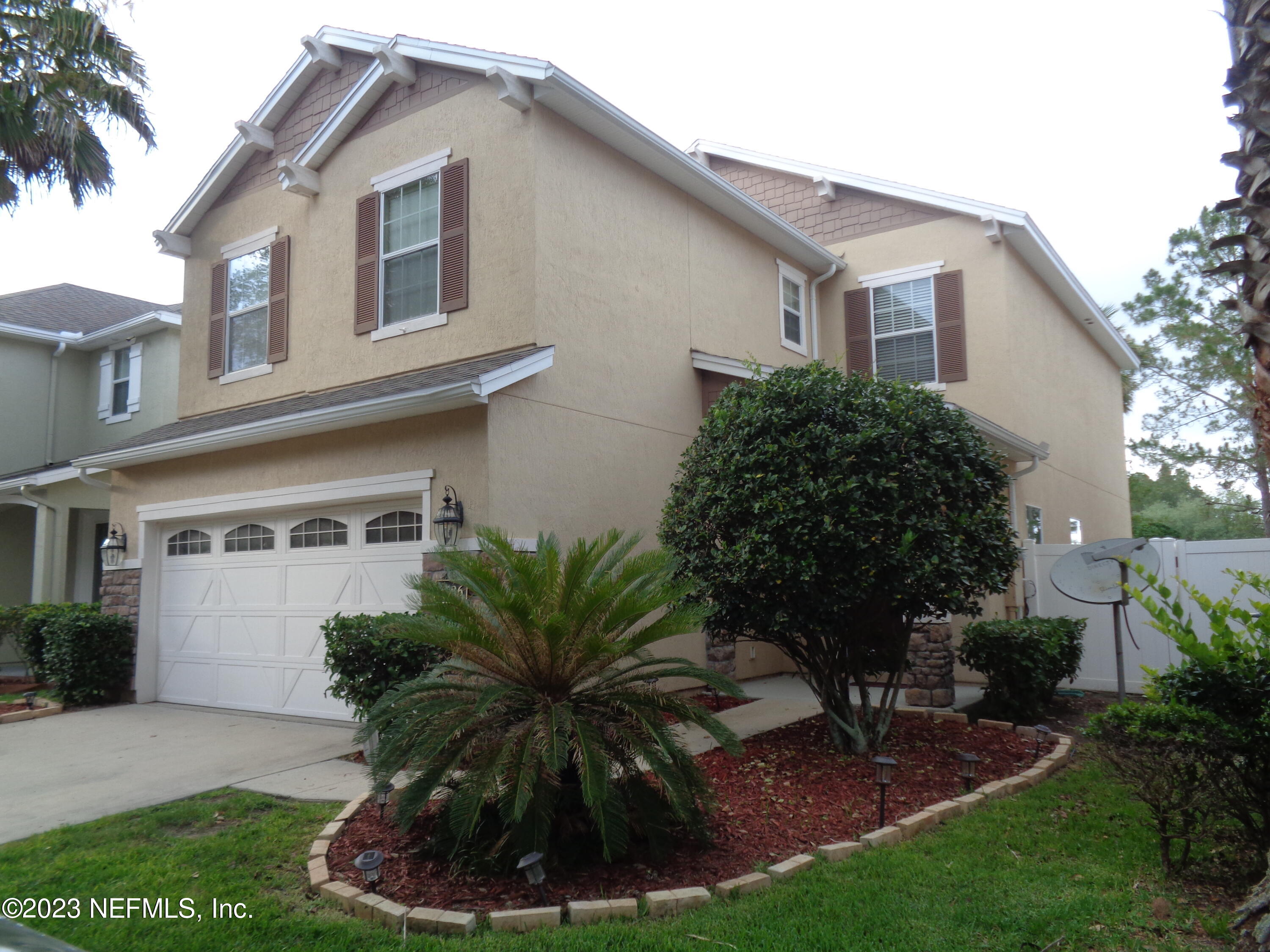 3786 Chasing Falls Road Orange Park, FL 32065 - Photo 2 of 26 a front view of a house with a garden