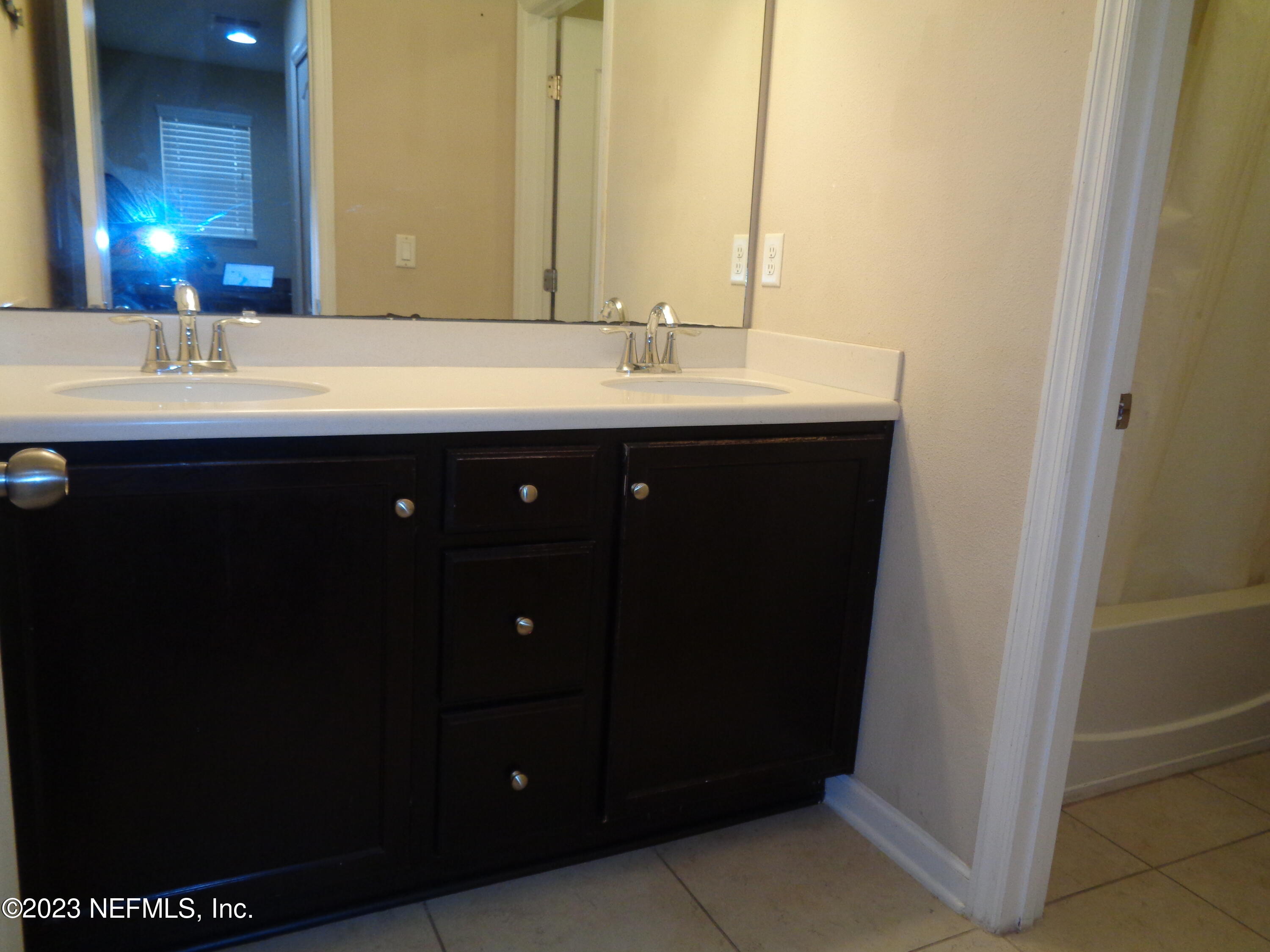 3786 Chasing Falls Road Orange Park, FL 32065 - Photo 21 of 26 a bathroom with a sink and a mirror