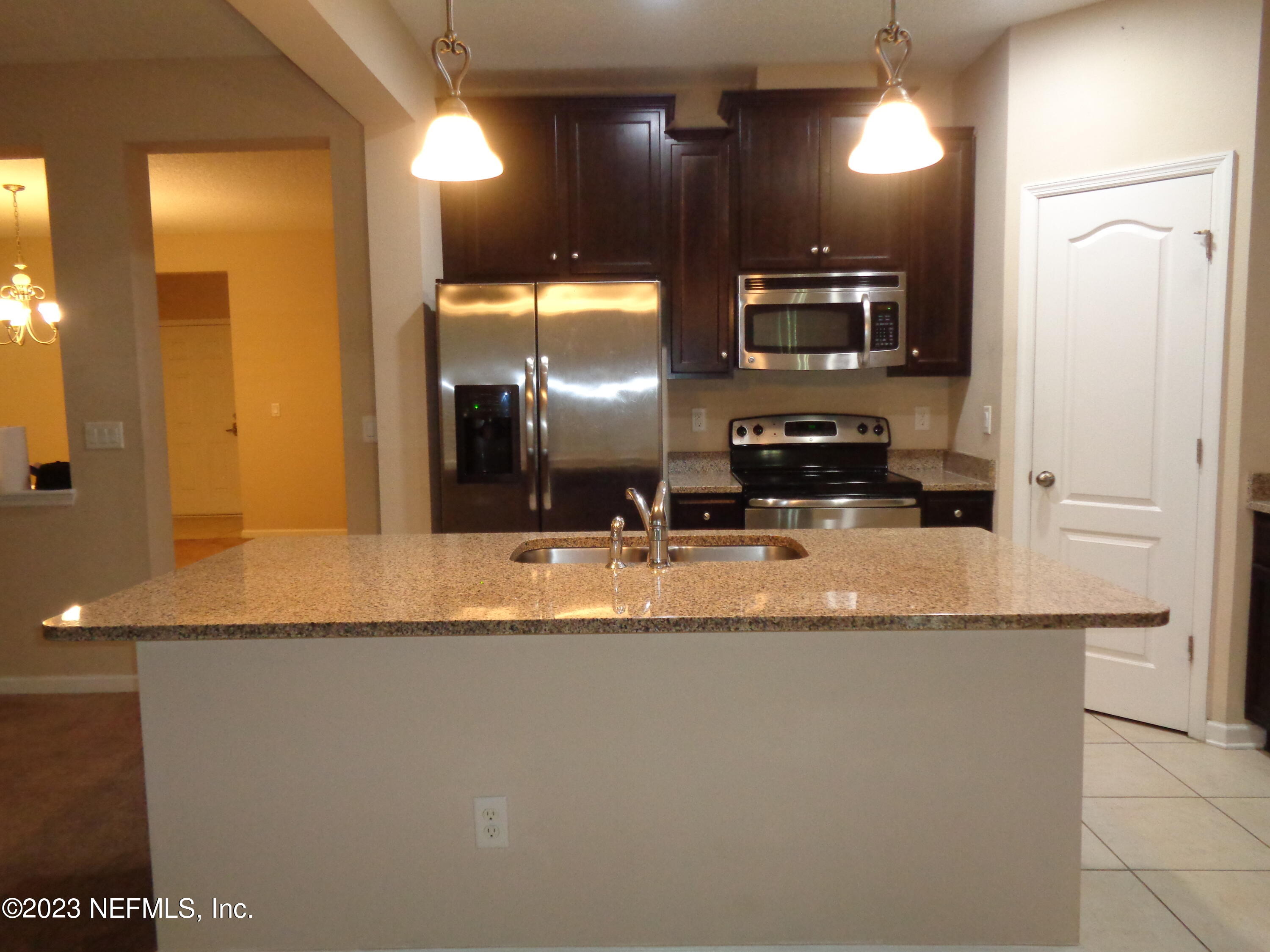 3786 Chasing Falls Road Orange Park, FL 32065 - Photo 7 of 26 a kitchen with stainless steel appliances granite countertop a sink and a refrigerator