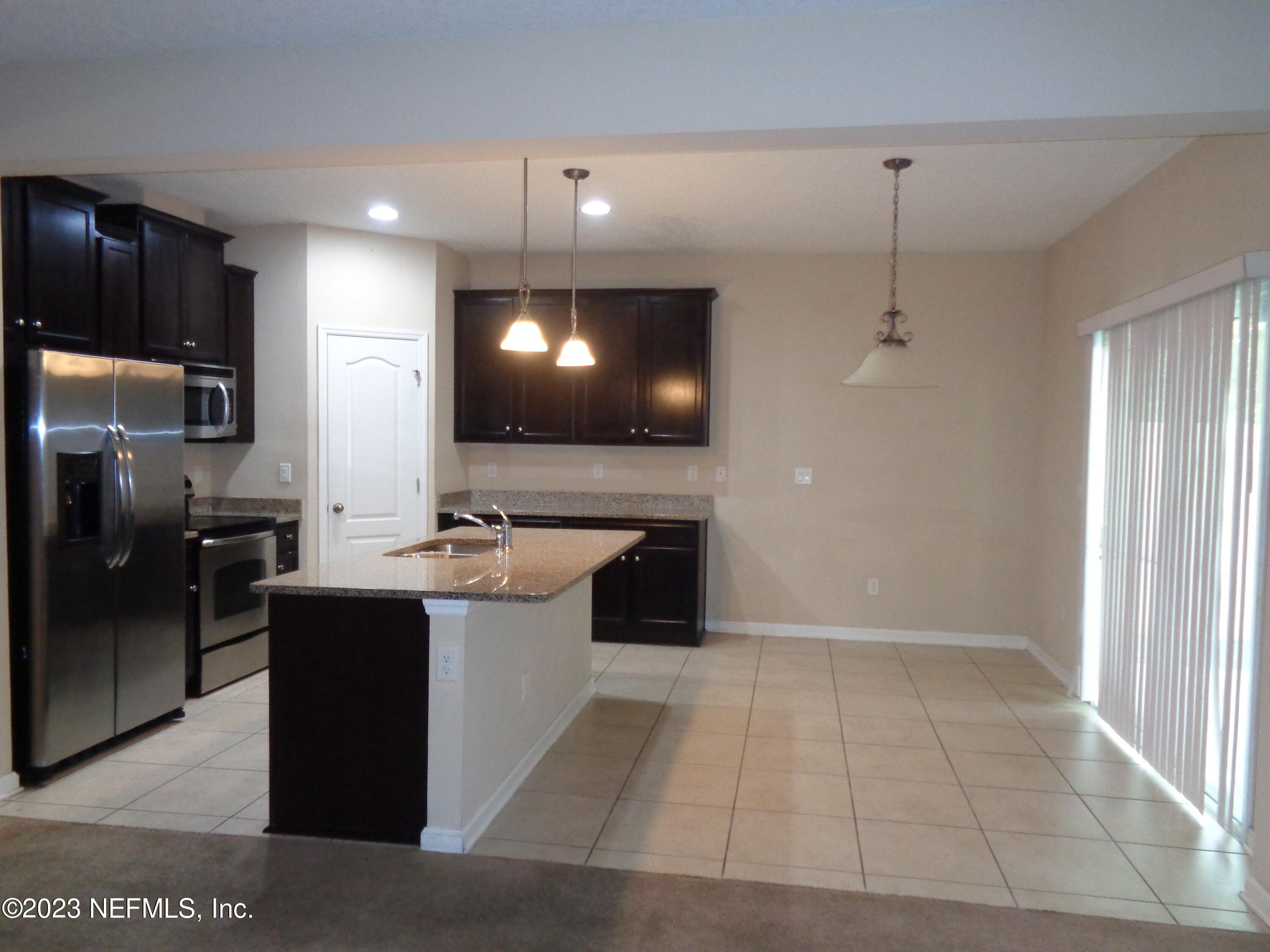 3786 Chasing Falls Road Orange Park, FL 32065 - Photo 8 of 26 a large kitchen with a sink stainless steel appliances and cabinets