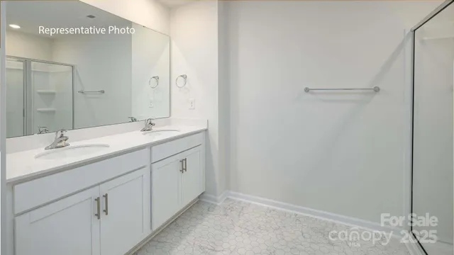 a bathroom with a glass shower door