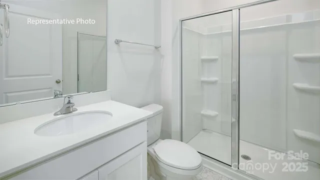 a bathroom with a granite countertop sink a toilet and bathtub