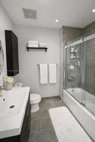 a view of a dining room with furniture and a floor to ceiling window