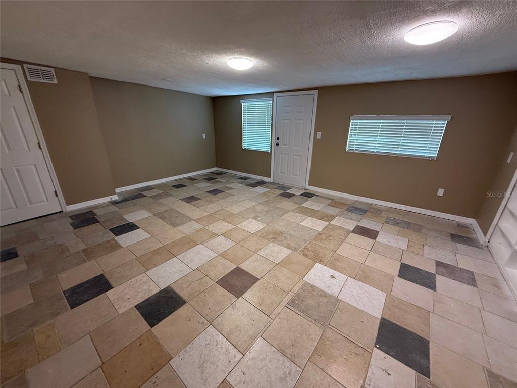 6104 Seabreeze Drive Port Richey, FL 34668 - Photo 18 of 25 a view of a livingroom with a black and white checkered floor