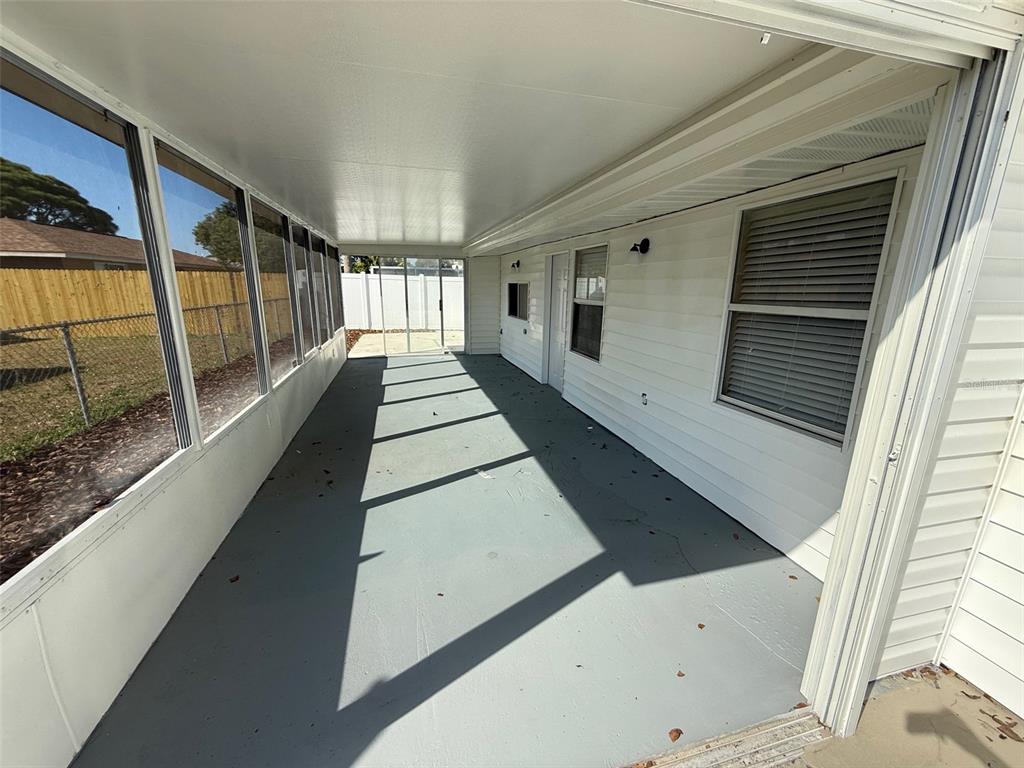 6104 Seabreeze Drive Port Richey, FL 34668 - Photo 19 of 25 a view of a back yard with wooden floor and stairs