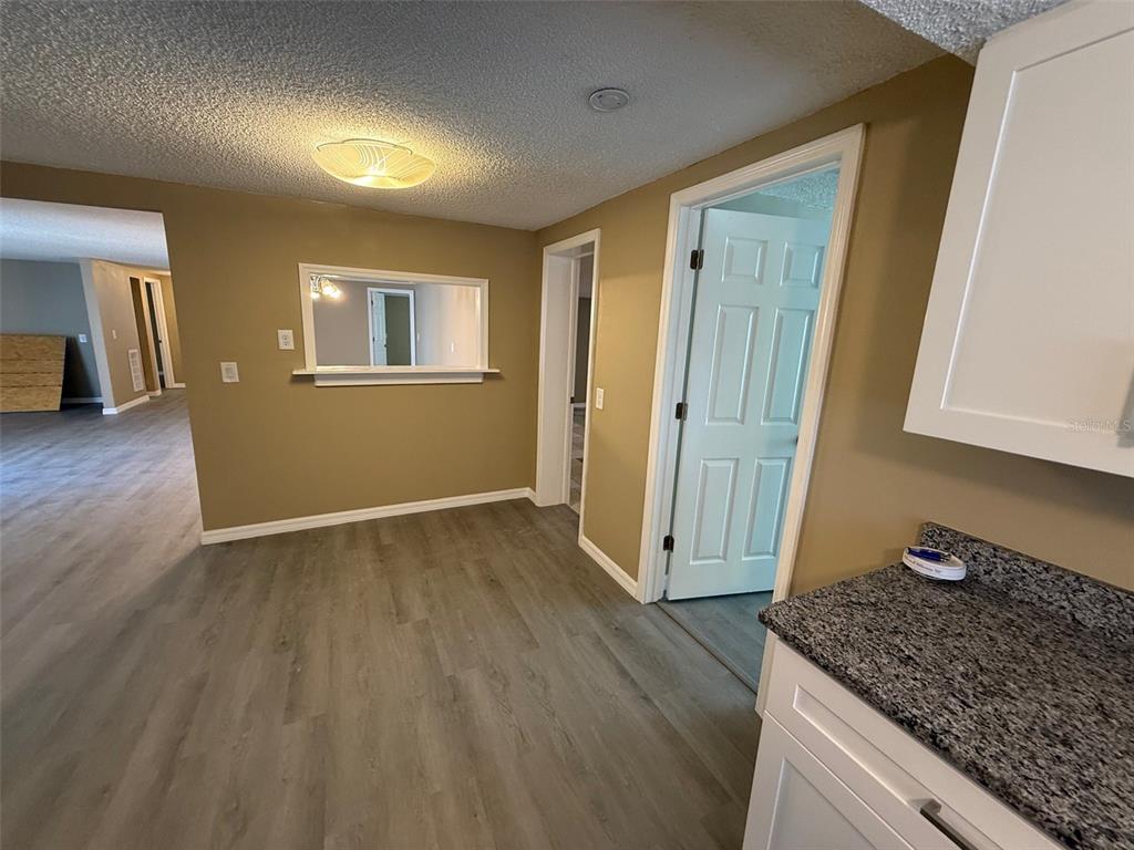 6104 Seabreeze Drive Port Richey, FL 34668 - Photo 9 of 25 a kitchen with granite countertop wooden cabinets a granite counter top and a sink