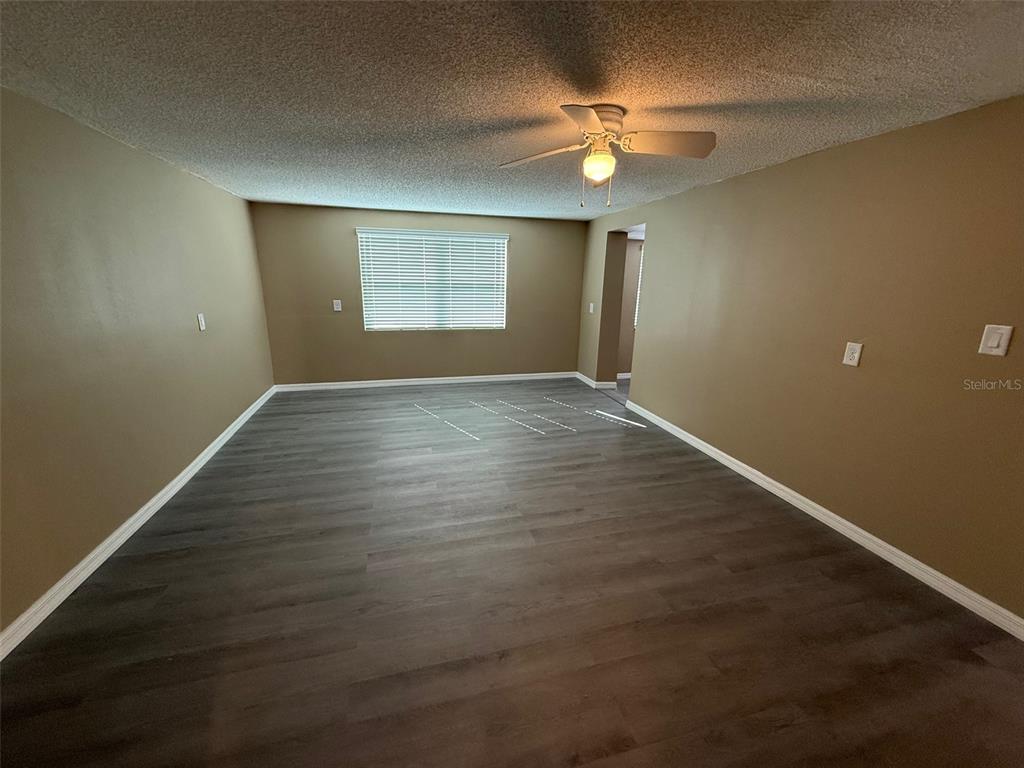 6104 Seabreeze Drive Port Richey, FL 34668 - Photo 10 of 25 a view of an empty room with window and chandelier fan
