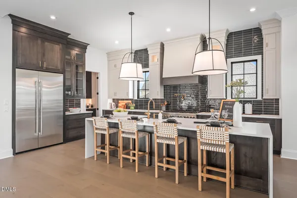 a large kitchen with a table and chairs