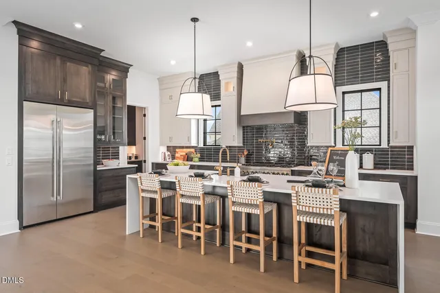 a large kitchen with a table and chairs