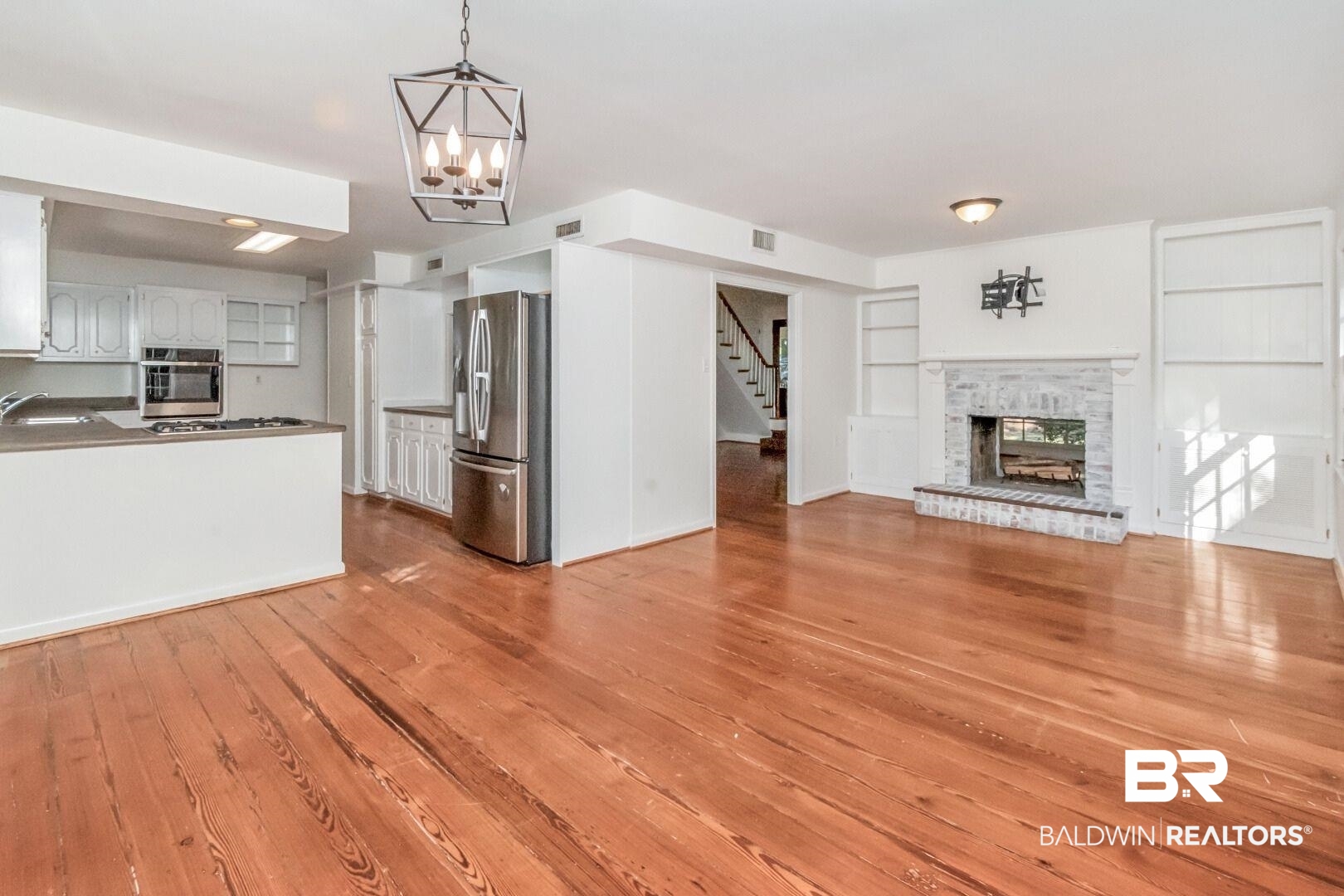 117 Ridgelawn Drive West Mobile, AL 36608 - Photo 8 of 31 Built in shelves, lots of natural light, beautiful wide plank pine wood floors, dual sided fireplace.
