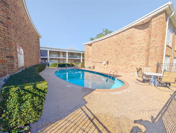 a view of a swimming pool with a lounge chairs