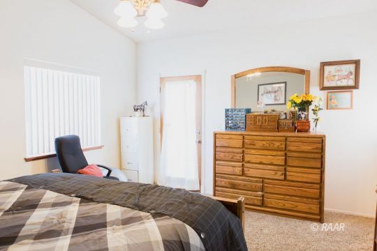 1112 Lee Avenue Ridgecrest, CA 93555 - Photo 17 of 29 a bedroom with a bed and a dresser