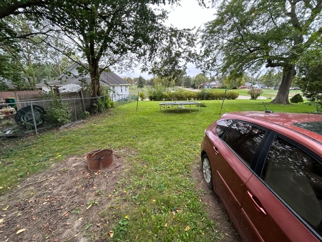 a view of a yard with a bench